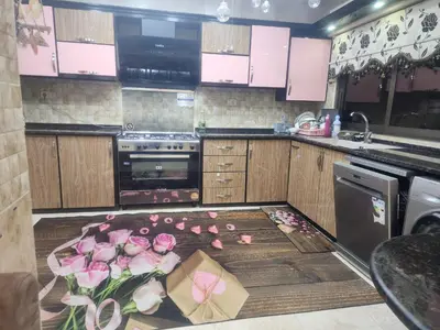 a kitchen with roses on the floor and a box at A big Family nice sunset flat in Amman
