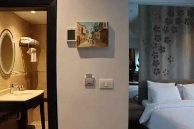a bathroom with a bed and a sink and a mirror at الأردن عمان in Irbid