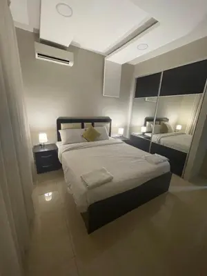 a bedroom with a large bed and a mirror at apartment 60m 1bedroom for rent4 in Amman