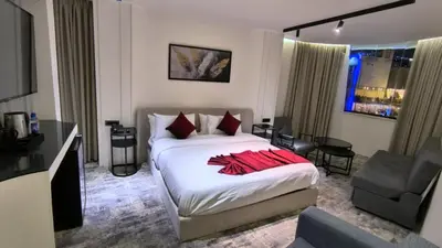 a bedroom with a bed with red pillows on it at Roya Downtown Boutique Hotel in Amman