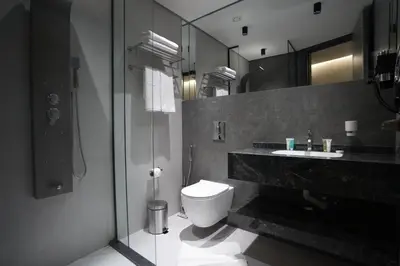 a bathroom with a toilet and a sink and a shower at Roya Downtown Boutique Hotel in Amman