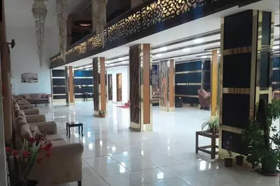 a lobby with couches and tables in a building at Althemar Hotel Ajloun -Jordan By Enala Hotels Group in Ajloun