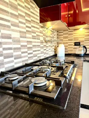 a kitchen with a stove top in a kitchen at Luxury 2 Bedroom Apartment in Amman