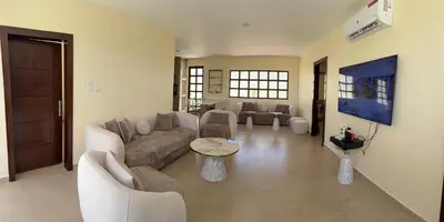 a living room with a couch and a tv at Giving Vibes Chalet in Amman