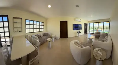 a large living room with couches and a tv at Giving Vibes Chalet in Amman