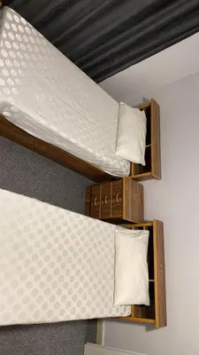 two bunk beds with white pillows at aljumirah furnished appartments الجميرا للشقق المفروشة in Az Zarqa