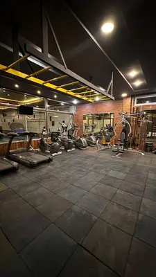 a gym with rows of exercise equipment in a room at Al-Amaari Gardens Compound 3092 in Irbid