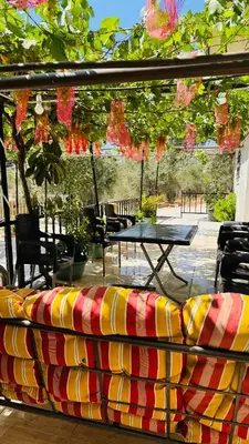 a colorful couch sitting on a patio with a table at شقة مفروشة في عجلون in Ajloun