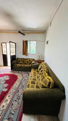 a living room with two couches and a rug at شقة مفروشة في عجلون in Ajloun