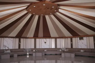 a room with a large tent with benches in it at Bubble Camp Wadi Rum in Wadi Rum