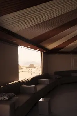 a living room with a couch and a view of the beach at Bubble Camp Wadi Rum in Wadi Rum