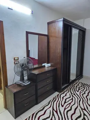 a bedroom with a dresser with a fan and a mirror at Rest & Relax Studio in Ajloun