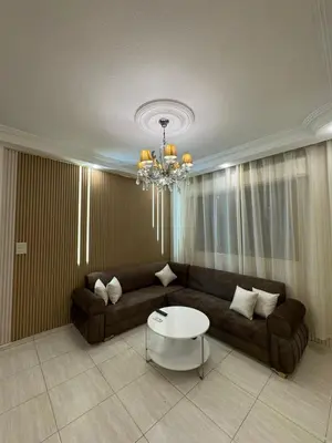 a living room with a couch and a table at stay by university of Jordan in Amman