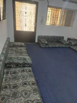 a room with two beds in front of a door at عجلون in Ajloun