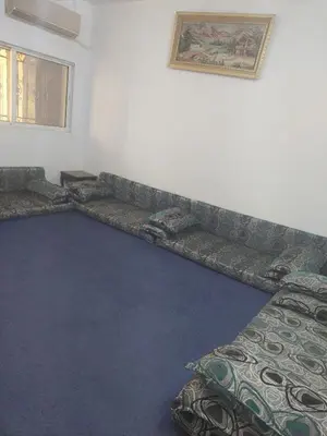 a living room with a couch in the corner at عجلون in Ajloun
