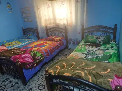 two beds sitting next to each other in a bedroom at عجلون in Ajloun