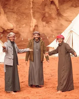 two men standing next to each other in the desert at The Legacy of Wadi Rum in Wadi Rum