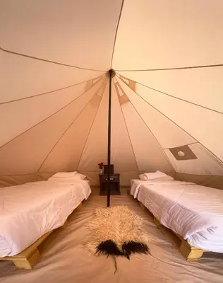 a room with two beds in a tent at The Legacy of Wadi Rum in Wadi Rum