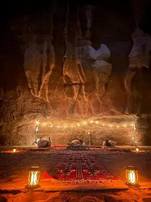 a stage with lights in a cave at night at The Legacy of Wadi Rum in Wadi Rum