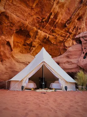 a white tent in front of a cliff at The Legacy of Wadi Rum in Wadi Rum