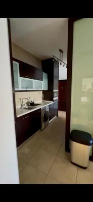 a large kitchen with a sink and a counter at Glow and Grace in Abdoun Best location in Amman