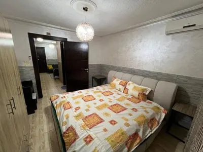 a bedroom with a bed and a room with a hallway at Central modern affordable studio in Amman