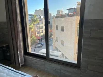 a view of a city street from a window at Central modern affordable studio in Amman