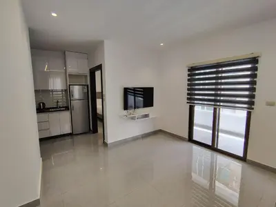 a kitchen with white walls and a large window at Masaken Hotel Apartment in Amman