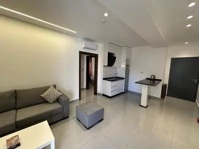 a living room with a couch and a table at Masaken Hotel Apartment in Amman