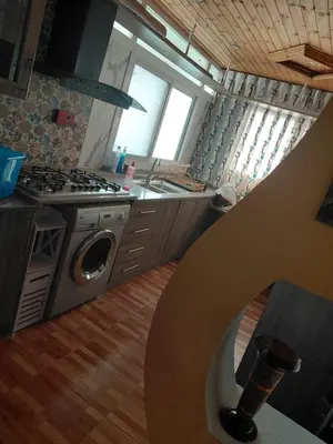 a kitchen with a stove top oven next to a sink at روف بانورامي باطلاله رائعه يسمح فقط للبنات او زوج وزوجة العمارة عائلية in Amman