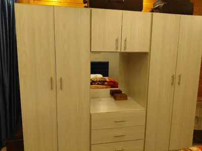 a closet with wooden cabinets and a drawer at روف بانورامي باطلاله رائعه يسمح فقط للبنات او زوج وزوجة العمارة عائلية in Amman