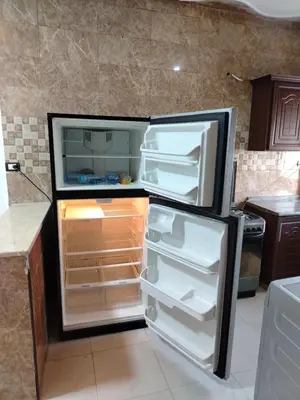 a refrigerator with its door open in a kitchen at الشقة الفاخرة Luxerios apartment in 0MM Nowwara in Amman