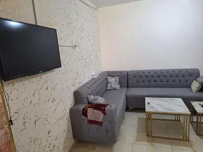 a living room with a couch and a flat screen tv at الشقة الفاخرة Luxerios apartment in 0MM Nowwara in Amman
