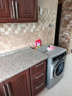 a kitchen with a washing machine on a counter at الشقة الفاخرة Luxerios apartment in 0MM Nowwara in Amman