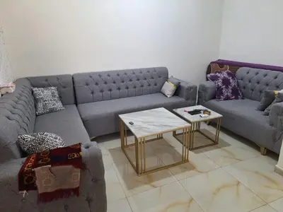a living room with two couches and a coffee table at الشقة الفاخرة Luxerios apartment in 0MM Nowwara in Amman