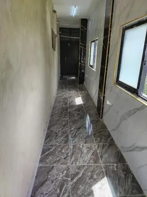 a hallway with a tile floor and a door at الشقة الفاخرة Luxerios apartment in 0MM Nowwara in Amman
