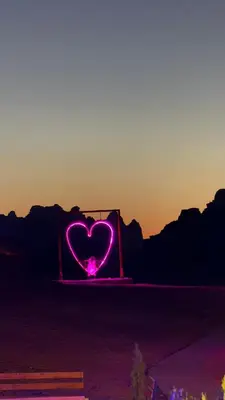 a heart sign with the sunset in the background at Rotana Wadi Rum in Wadi Rum