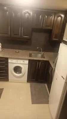 a kitchen with a sink and a washing machine at lNTERCoNTlNENTALAL in Amman