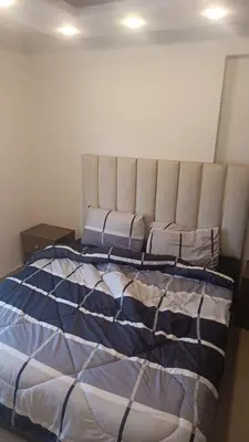 a bedroom with a bed with two pillows on it at lNTERCoNTlNENTALALALx in Amman