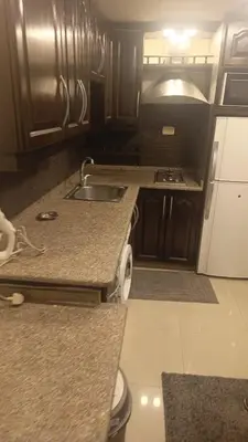 a kitchen with a sink and a counter top at lNTERCoNTlNENTALALALx in Amman