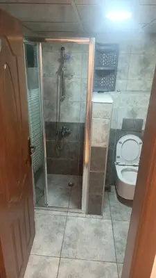 a bathroom with a shower and a toilet at lNTERCoNTlNENTALALALx in Amman