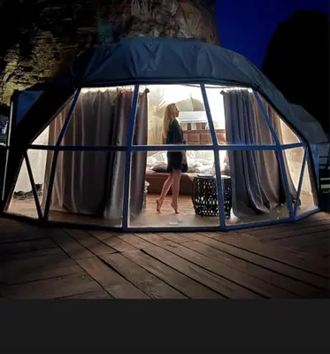 a woman walking inside of a gazebo at DESERT BREATHS lUXURY CAMP in Wadi Rum