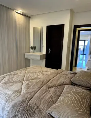 a bedroom with a large bed and a window at The view in Māḩiş