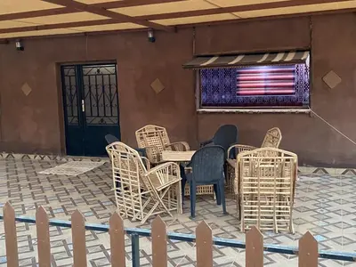 a patio with chairs and a table with an american flag at Shadow of Rum camp in Wadi Rum