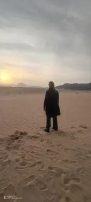 a man standing in the sand in the desert at Shadow of Rum camp in Wadi Rum