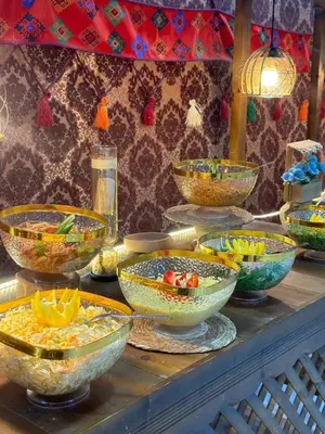 a buffet of bowls of food on a table at Siq Rum Luxury Camp in Wadi Rum