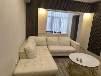 a living room with a white couch and a table at الفاروق in Amman