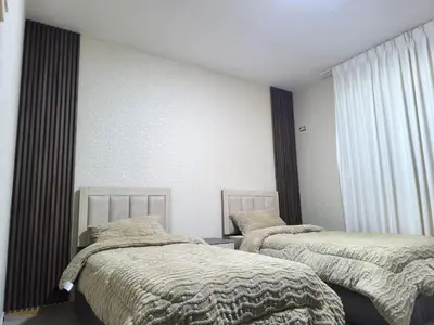 a bedroom with two beds and curtains at الفاروق in Amman