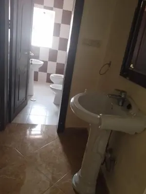 a bathroom with a sink and two toilets at Furnished apartment for rent in Amman