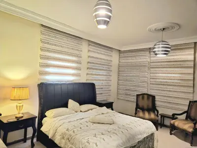 a bedroom with a bed and a chair at Red Sea Pearl Luxury Villa in Aqaba in Aqaba